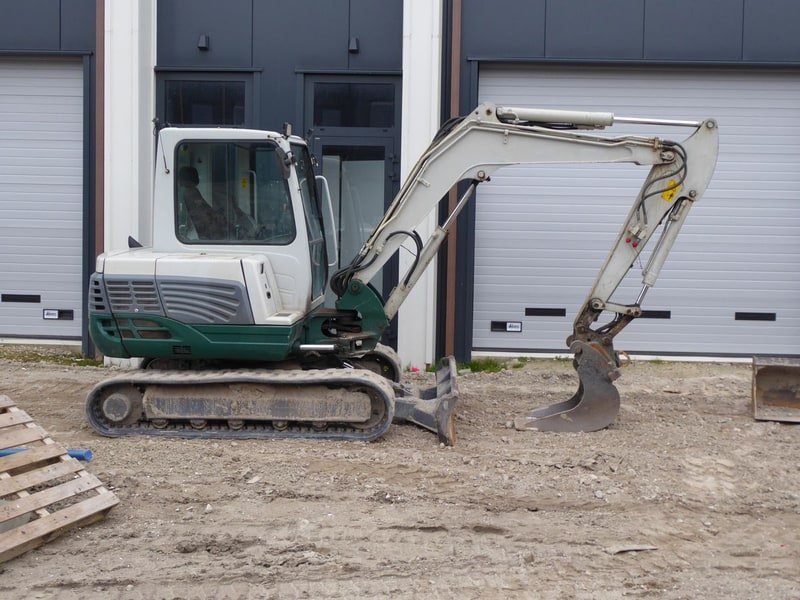 1.8 Ton Mini Excavator: QS-18 Price and Applications - mini excavator working on a construction site