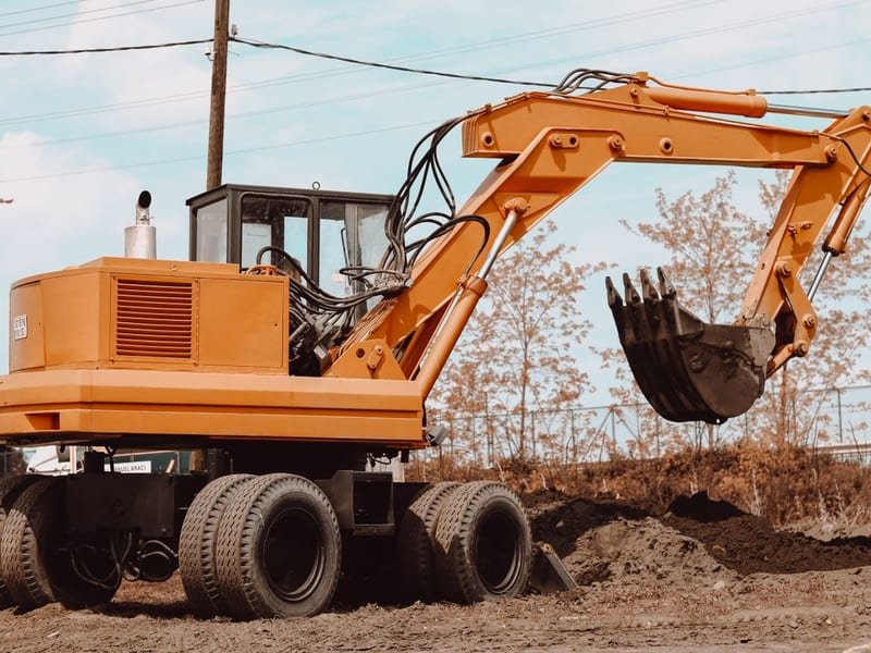 Compact Mini Excavator: Best Uses and Specs - mini excavator working on a construction site
