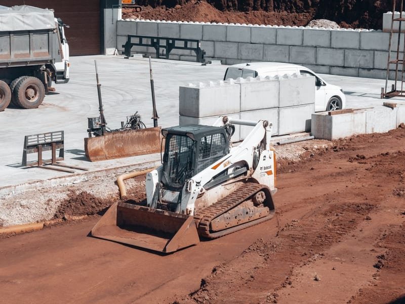 How to Level Ground with a Mini Excavator - compact excavator at a construction site