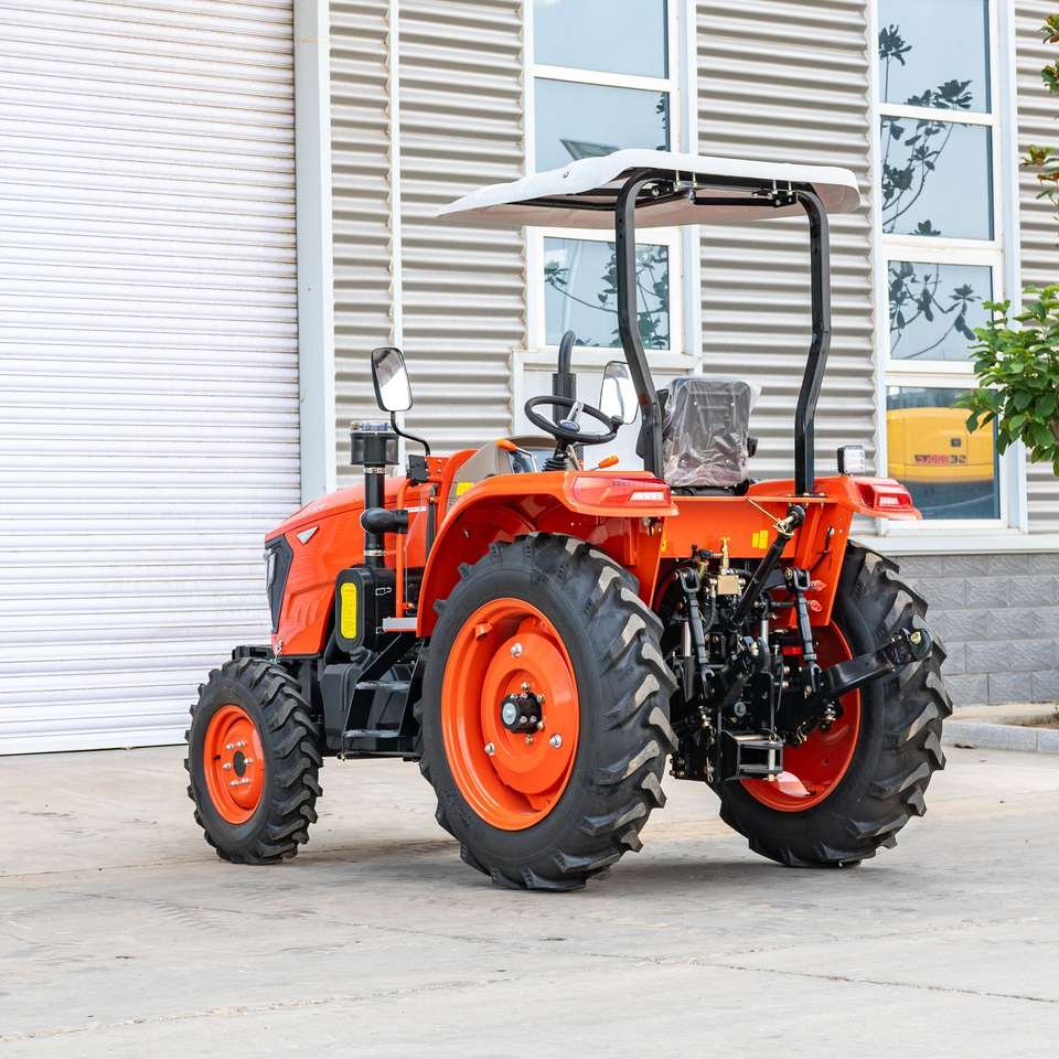 Orange farm tractor with rear linkage and canopy