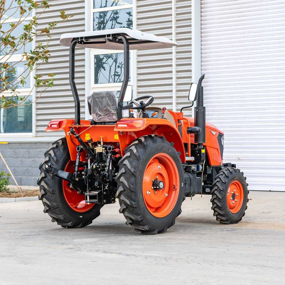 Orange compact agricultural tractor with canopy
