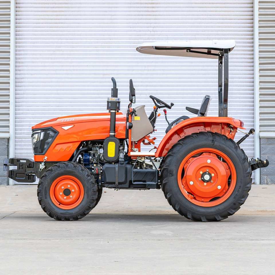 Orange utility tractor with canopy, side view